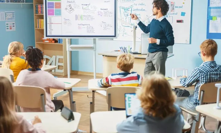 Teacher using an interactive board in a classroom
